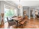 Elegant dining room with wood floors, modern chandelier, and sliding glass doors to outside at 542 Lochaven Rd, Waxhaw, NC 28173