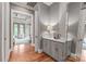 Hallway with hardwood floors, gray cabinets, and decor at 542 Lochaven Rd, Waxhaw, NC 28173
