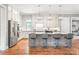 Bright kitchen featuring a large kitchen island with bar stool seating at 542 Lochaven Rd, Waxhaw, NC 28173