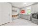 Well-organized laundry room with built-in storage, granite countertops, and modern appliances at 542 Lochaven Rd, Waxhaw, NC 28173
