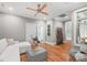 This living room features hardwood floors, a white couch, a ceiling fan, and modern decorations at 542 Lochaven Rd, Waxhaw, NC 28173
