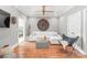 This living room has hardwood floors, a white couch, a ceiling fan, and modern decor at 542 Lochaven Rd, Waxhaw, NC 28173