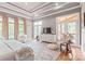 Main bedroom boasts hardwood floors, trey ceilings, a ceiling fan, a large rug, and access to a private patio at 542 Lochaven Rd, Waxhaw, NC 28173