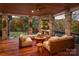 Inviting covered deck featuring a stone fireplace, wood ceiling and comfortable seating at 542 Lochaven Rd, Waxhaw, NC 28173