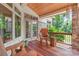 Relaxing covered porch with wooden floors and a stone accent wall at 542 Lochaven Rd, Waxhaw, NC 28173