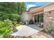 Beautiful backyard patio features a fountain, stone accents, grill, and lush landscaping at 542 Lochaven Rd, Waxhaw, NC 28173