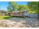 Charming backyard with wooden deck, well-manicured lawn, and mature trees at 576 Scaleybark Rd, Charlotte, NC 28209