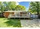 Lush backyard featuring a large wooden deck, and beautiful green grass at 576 Scaleybark Rd, Charlotte, NC 28209