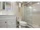 Bright bathroom with a new glass-door shower, modern toilet, and stylish vanity at 576 Scaleybark Rd, Charlotte, NC 28209