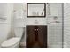 Cozy bathroom with white subway tile shower and dark wood vanity cabinet at 576 Scaleybark Rd, Charlotte, NC 28209