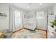 Bright Bedroom with white crib, whimsical decor, and ample natural light at 576 Scaleybark Rd, Charlotte, NC 28209