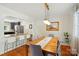 Bright dining room with kitchen view features a wooden table and pendant lighting at 576 Scaleybark Rd, Charlotte, NC 28209