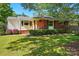 Charming brick home featuring a well-manicured lawn and lush landscaping at 576 Scaleybark Rd, Charlotte, NC 28209