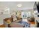 Living room with hardwood floors, fireplace, and access to outdoor space at 576 Scaleybark Rd, Charlotte, NC 28209