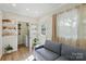 Comfortable living room features a sofa, bright windows, and laundry area at 576 Scaleybark Rd, Charlotte, NC 28209