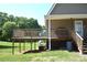 Covered back porch with wood railing overlooking a sprawling back yard at 5769 Birch St, Conover, NC 28613