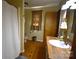 Bathroom with wooden floors features a modern vanity, sink and faucet, toilet and walk-in shower with a white curtain at 5769 Birch St, Conover, NC 28613