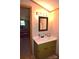 Bathroom vanity featuring a mirror, drawers, and cabinets, illuminated by stylish lighting at 5769 Birch St, Conover, NC 28613