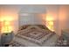 Comfortable bedroom with a decorative quilt, lamps, and neutral walls at 5769 Birch St, Conover, NC 28613