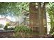 Back exterior of home with large deck, chimney, and stairs, all surrounded by mature trees at 5769 Birch St, Conover, NC 28613