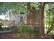 Back exterior of home with large deck, chimney, and stairs, all surrounded by mature trees at 5769 Birch St, Conover, NC 28613