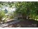 Charming home featuring a wooden porch, landscaped garden, and inviting walkway to the front door at 5769 Birch St, Conover, NC 28613