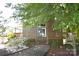 Charming home featuring a welcoming porch and beautiful landscaping, shaded by mature trees at 5769 Birch St, Conover, NC 28613