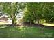 Front yard featuring mature trees and lush green grass at 5769 Birch St, Conover, NC 28613