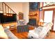 Cozy living room with fireplace, hardwood floors, comfortable seating, and staircase access at 5769 Birch St, Conover, NC 28613