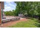 Spacious backyard with a wood deck, patio with fire pit, storage shed, and green lawn at 618 Circle Trace Rd, Monroe, NC 28110