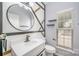 Modern bathroom features a round mirror, contemporary lighting, and sleek fixtures at 618 Circle Trace Rd, Monroe, NC 28110