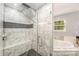 Close up of new tile shower with rainfall shower head and glass door at 618 Circle Trace Rd, Monroe, NC 28110