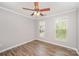 Spacious bedroom with chair rail, ceiling fan, and two bright windows at 618 Circle Trace Rd, Monroe, NC 28110