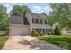 Two-story home featuring a classic design, attached garage, driveway, and well-manicured landscaping on a sunny day at 618 Circle Trace Rd, Monroe, NC 28110