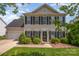 Charming two-story home with black shutters, landscaped yard, and attached garage. Beautiful curb appeal at 618 Circle Trace Rd, Monroe, NC 28110
