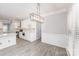 Bright eat-in kitchen features white cabinets, stone countertops, stainless appliances, and modern light fixture at 618 Circle Trace Rd, Monroe, NC 28110