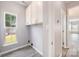 Well-lit laundry room features a window and built in cabinets for easy storage at 618 Circle Trace Rd, Monroe, NC 28110