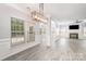Open-concept living room with gray walls, wood-look tile flooring, fireplace, and many windows at 618 Circle Trace Rd, Monroe, NC 28110