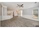 Spacious room with neutral walls, white trim, and wood floors open to the kitchen and dining areas at 618 Circle Trace Rd, Monroe, NC 28110