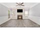 Spacious living room featuring a fireplace, neutral paint, modern ceiling fan, and wood flooring at 618 Circle Trace Rd, Monroe, NC 28110