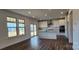 Bright, open kitchen with stainless appliances, island, and sliding glass doors at 642 Amberjack Pl # 75, York, SC 29745