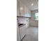 Bright laundry room featuring white cabinets, tile flooring, and a stainless steel sink for added convenience at 642 Amberjack Pl # 75, York, SC 29745