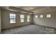 Spacious main bedroom with carpet, ample natural light and tray ceiling at 642 Amberjack Pl # 75, York, SC 29745