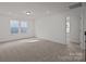 Bright bedroom featuring neutral carpeting, two large windows, and an open doorway at 642 Amberjack Ln, York, SC 29745