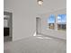 Well-lit bedroom features neutral carpet, two bright windows, and an ensuite bathroom at 642 Amberjack Ln, York, SC 29745