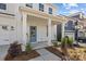 Charming front porch with a blue door, white columns, and landscaping at 642 Amberjack Ln, York, SC 29745