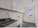 Functional laundry room with modern sink, cabinetry, and tiled floors at 642 Amberjack Ln, York, SC 29745