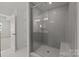 Modern bathroom with a large tiled shower, glass door, and built-in bench at 642 Amberjack Ln, York, SC 29745