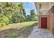 Green backyard with a mix of trees and shrubs, complemented by a brick home exterior at 680 Lakeside Dr, Rock Hill, SC 29730