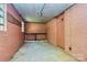 Unfinished basement with exposed brick walls, a workbench, and a utilitarian design at 680 Lakeside Dr, Rock Hill, SC 29730